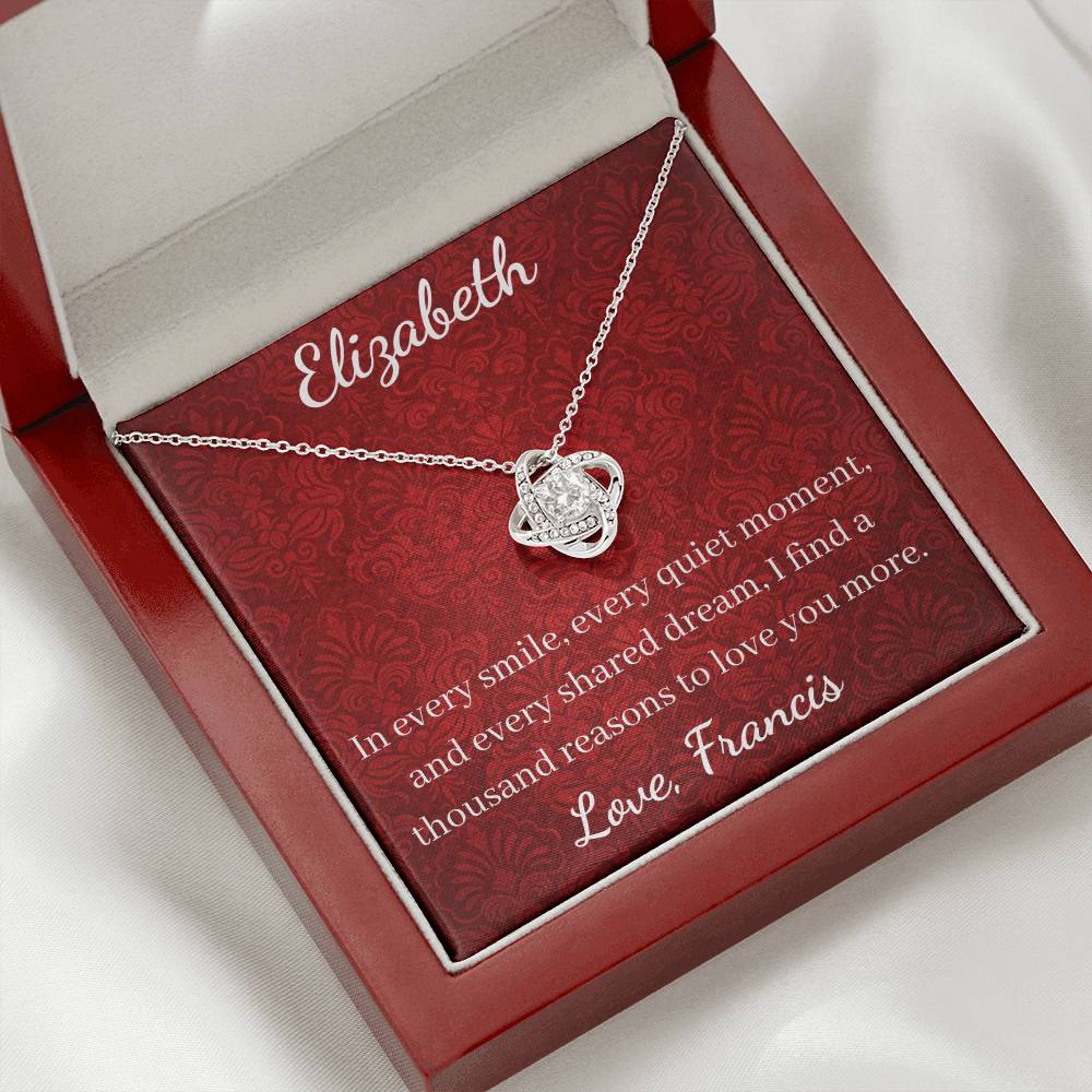 Silver necklace in a red jewelry box with engraved message