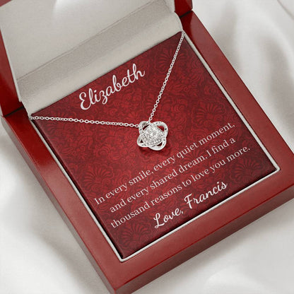 Silver necklace in a red jewelry box with engraved message